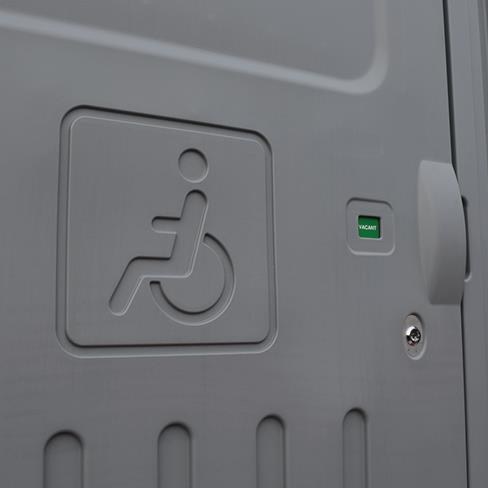 Door with accessibility symbol and vacancy indicator